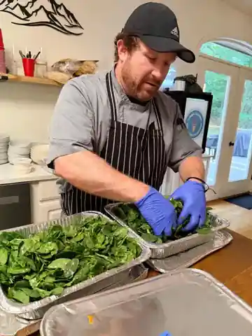 Chef Zak Hampton preparing spinach salads in an Asheville NC kitchen